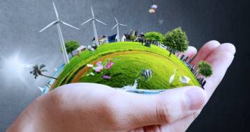 Hand met duurzame en groene wereld met windmolens